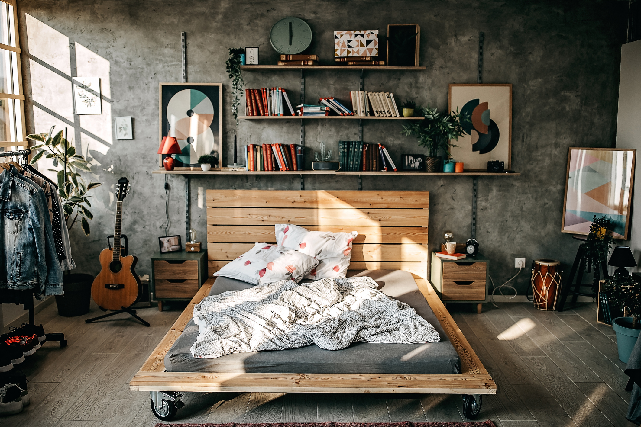 A room littered with objects and an unmade bed