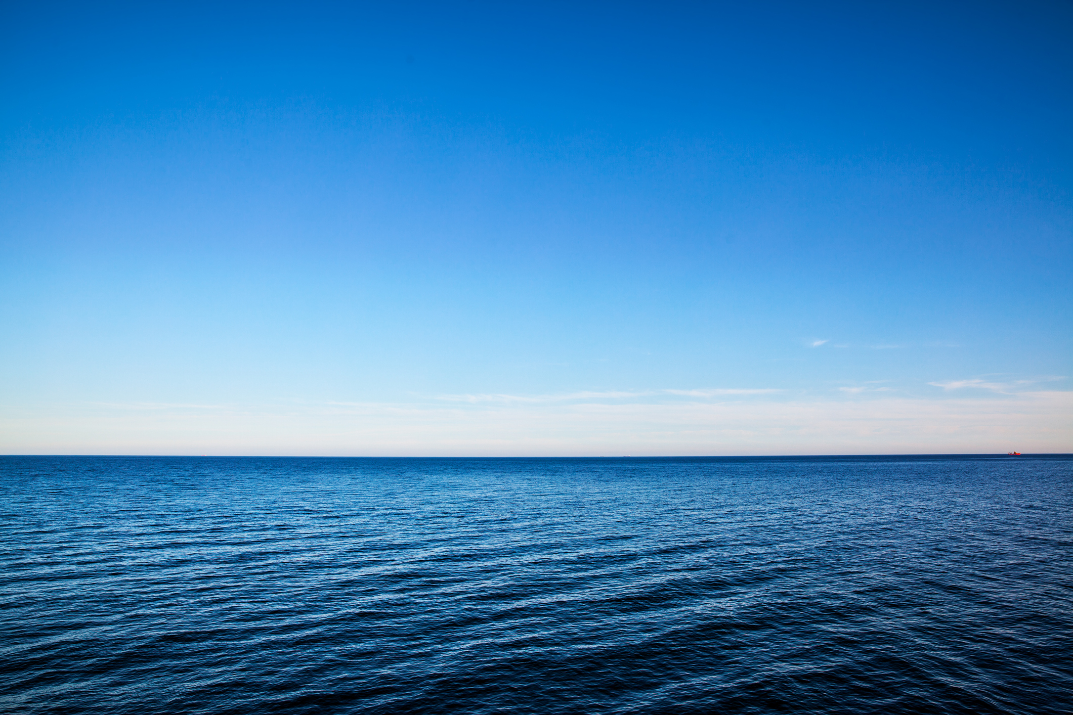 A calm, empty ocean and blue sky