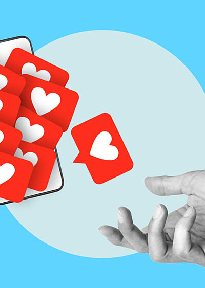 Social media likes fall from a smartphone to an open hand.