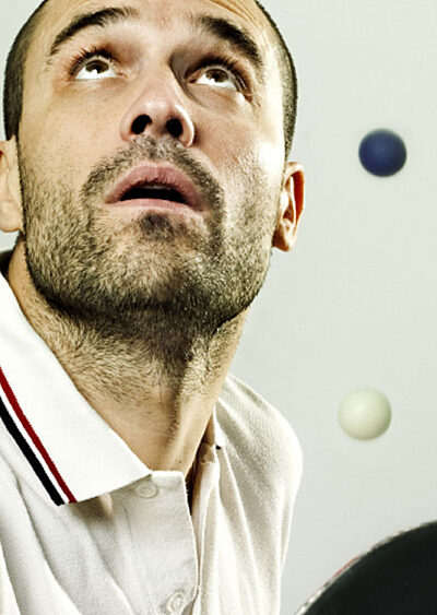 Man looking up with colourful balls in the background