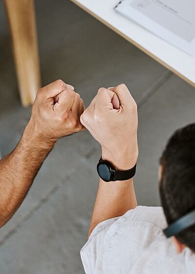 Two colleagues bumping fists