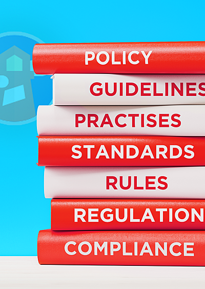 A stack of red and white books on a table with titles related to guidelines, standards, and compliance