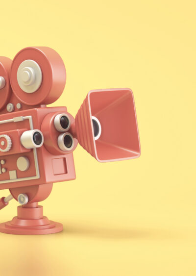 Red movie camera on yellow background.