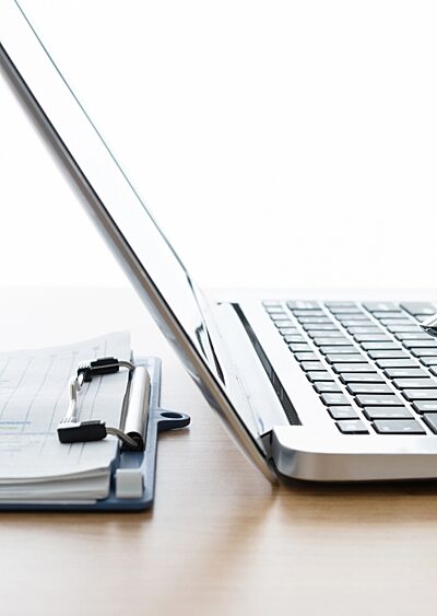 Robot hand using laptop and man hand writing