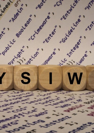 WYSIWYG on Wooden Dice with internet terms printed on paper