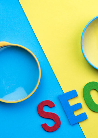 Image of two magnifying glasses on bright blue and yellow background