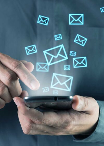 Man on Phone with email icons floating up