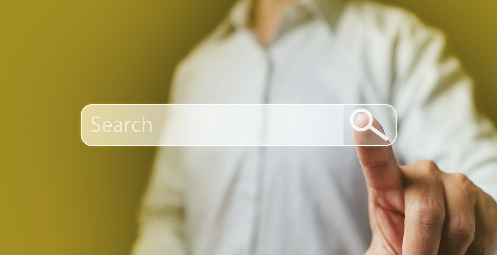 A businessman reaching out to press a search bar in front of him.