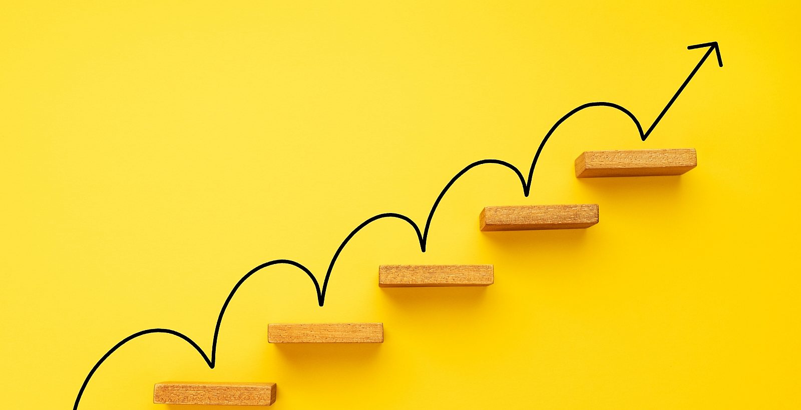 An arrow climbing stairs on a yellow background.