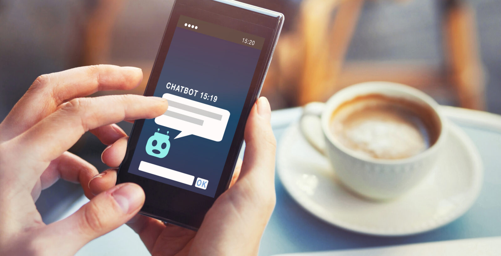 Person on phone with chat bot and a coffee in the background