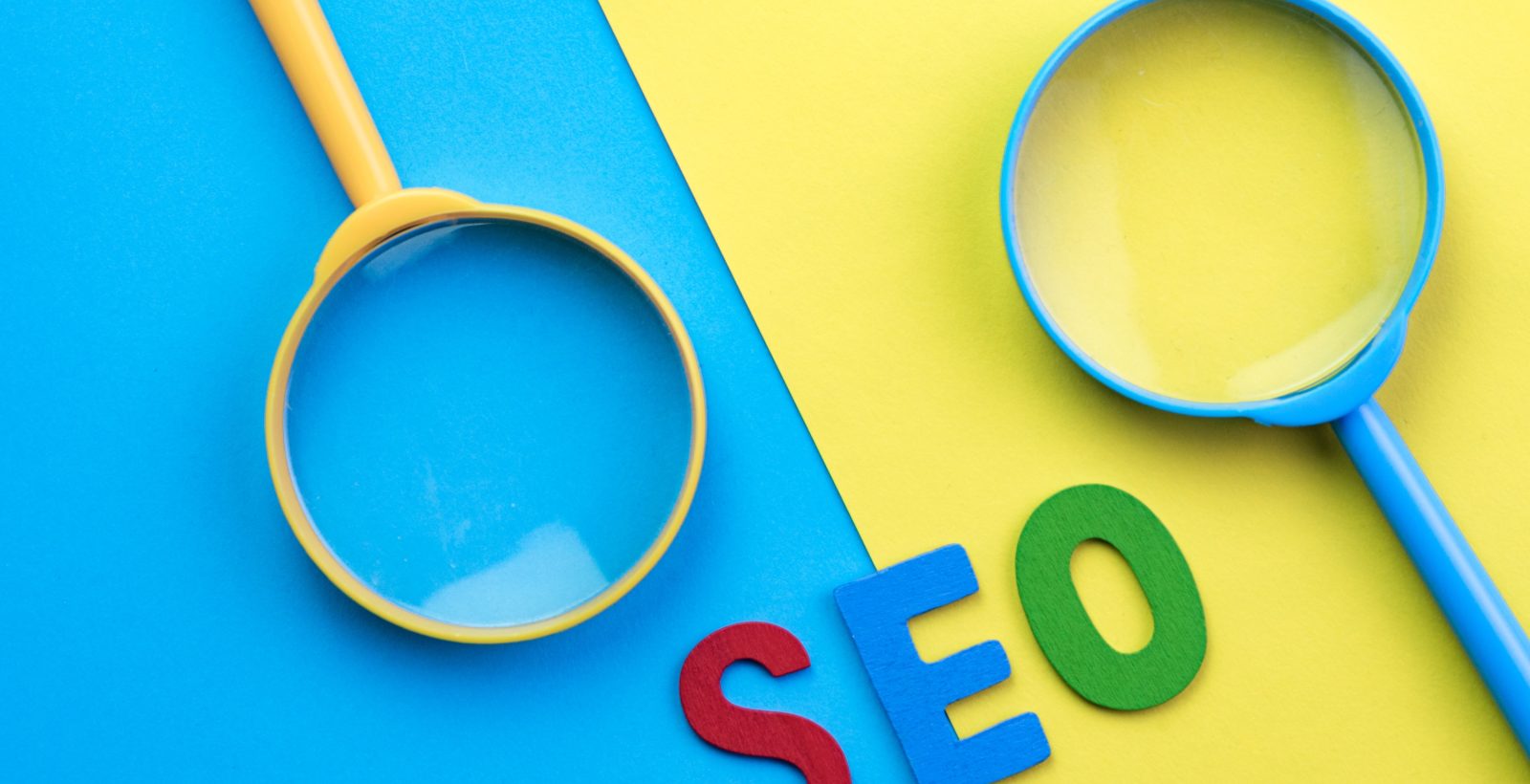 Image of two magnifying glasses on bright blue and yellow background