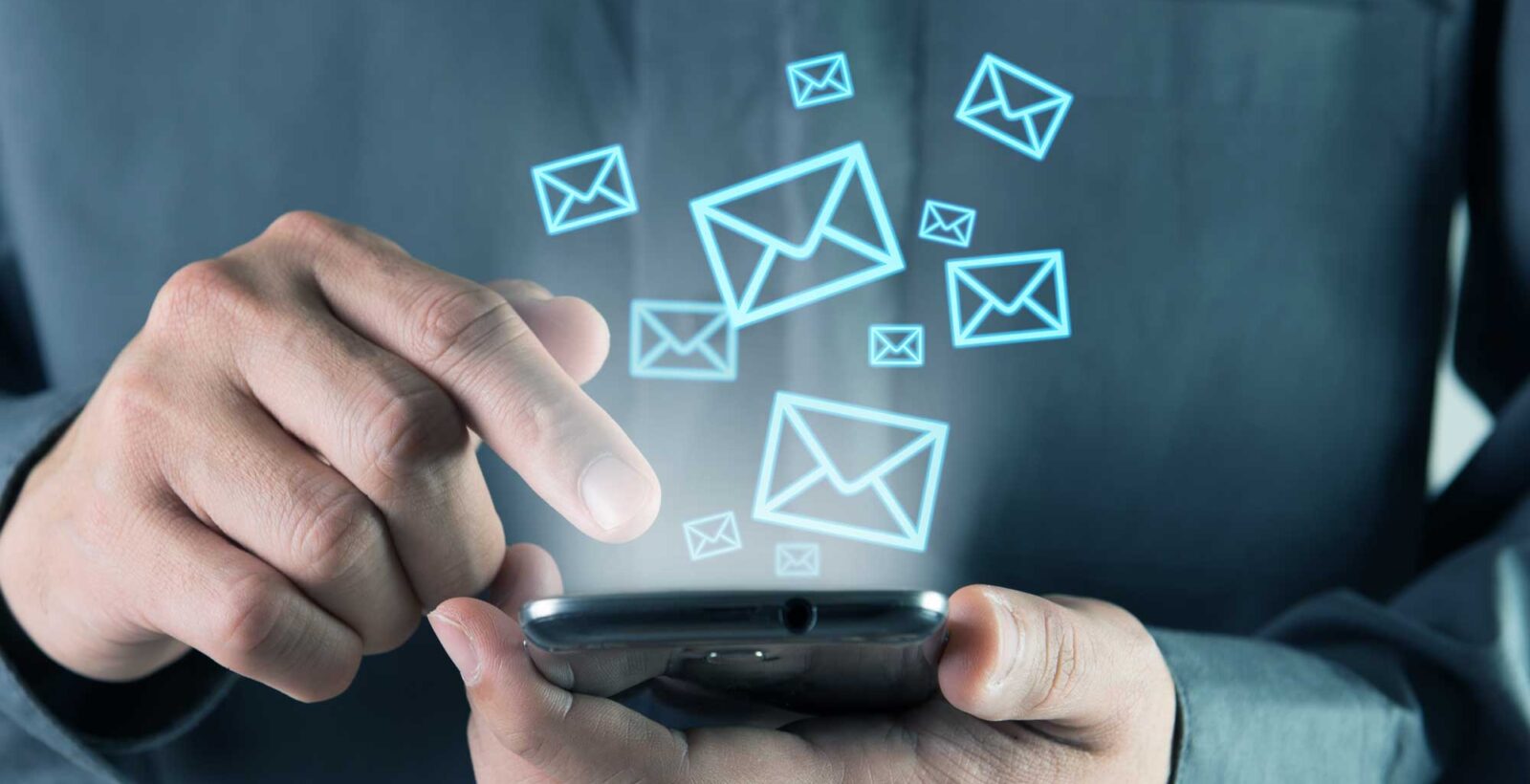 Man on Phone with email icons floating up